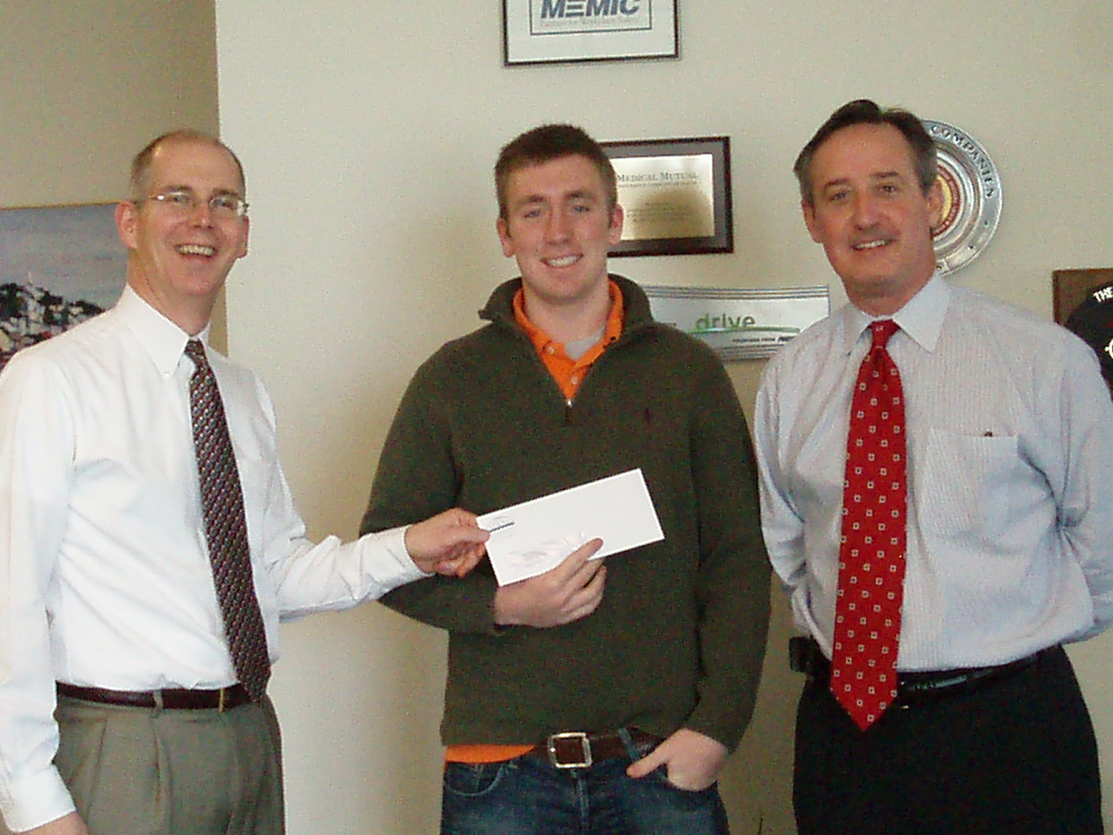 Adam collects his prize from Noyes Hall & Allen Insurance